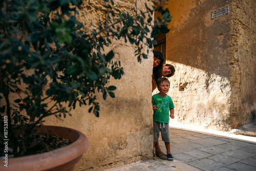 Young family with the child on the excursion in Mdina, Malta
