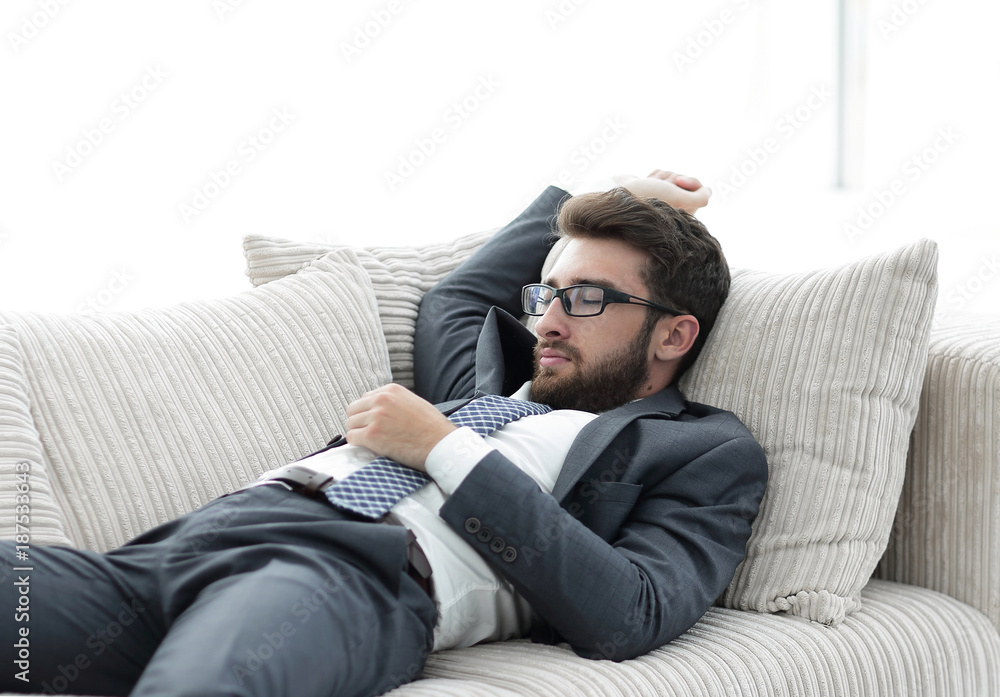 tired businesswoman relaxing on the couch. tired businesswoman relaxing on the couch.
