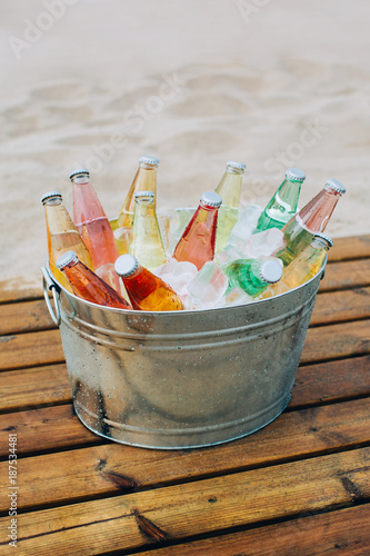 Beverage cooler full of drinks on the beach.
