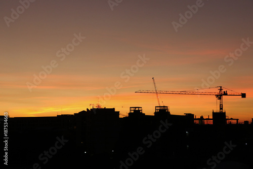 Silhouette building construction and crane with sunset background sky gold color beauty in nature background