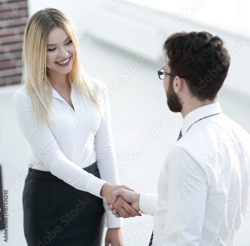 handshake business partners in the office.