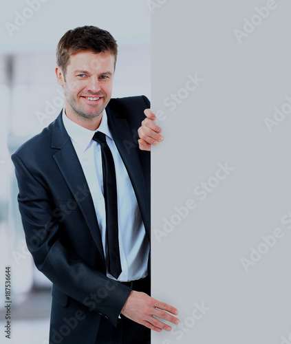 Handsome Businessman holding a blank sign in front of him.
