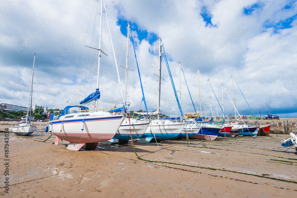 Boats in the bay at low tide in Tenby bay, Wales