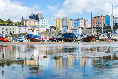 Boats in the bay at low tide with town view in Tenby bay, Wales photo