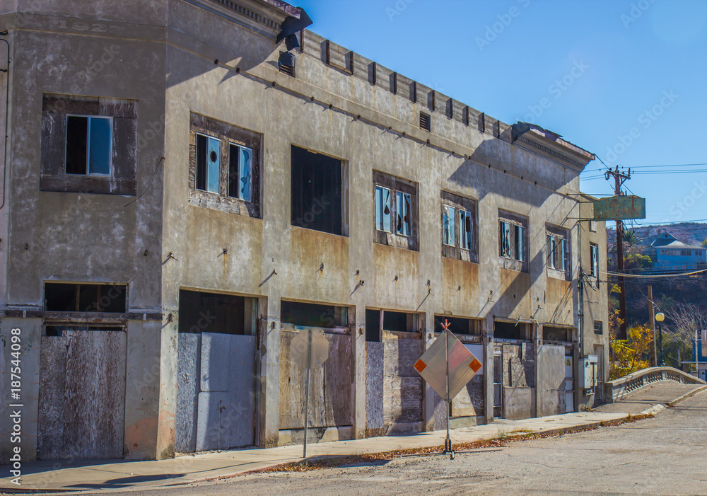 Abandoned Two Story Building With Boarded Up Doors
