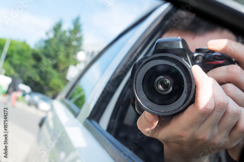 photographer with camera take photo from the car window
