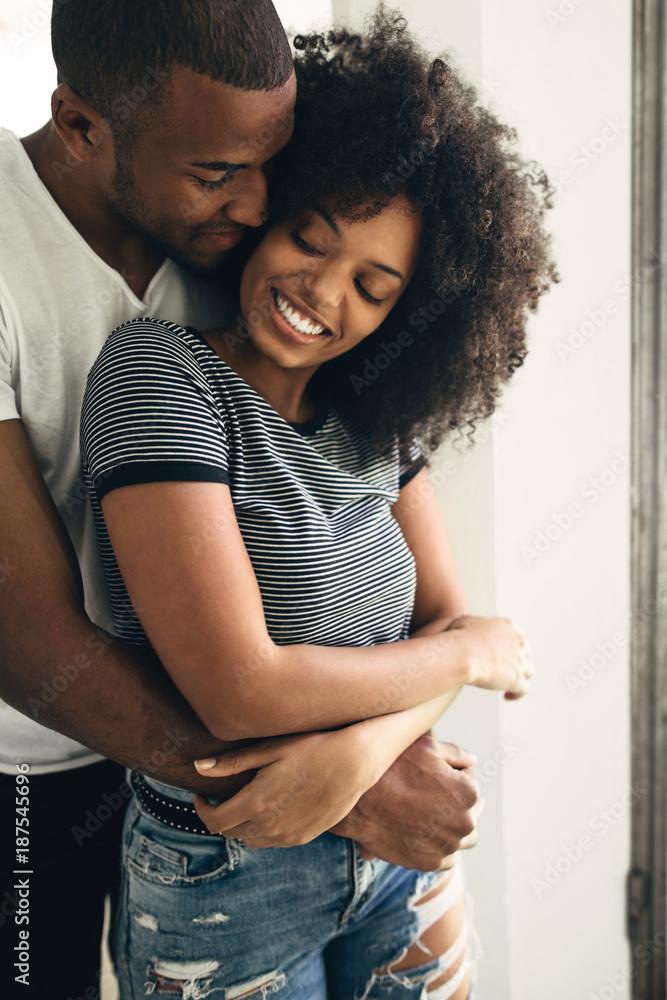 Young black couple embracing at home Stock Photo Adobe Stock
