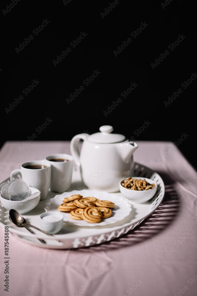 Tray served with tea set and cookies Tray served with tea set and cookies