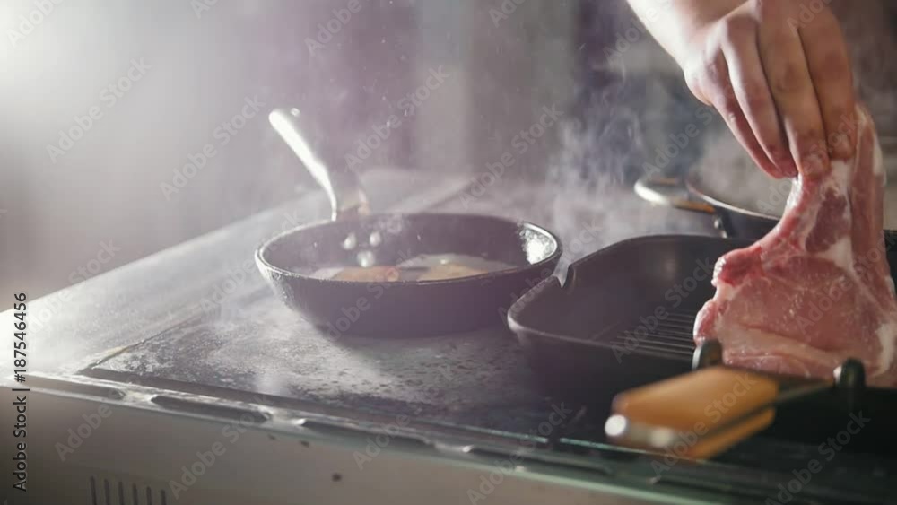 Chef in restaurant is frying meat and vegetables in a pan, slow-motion Chef in restaurant is frying meat and vegetables in a pan, slow-motion