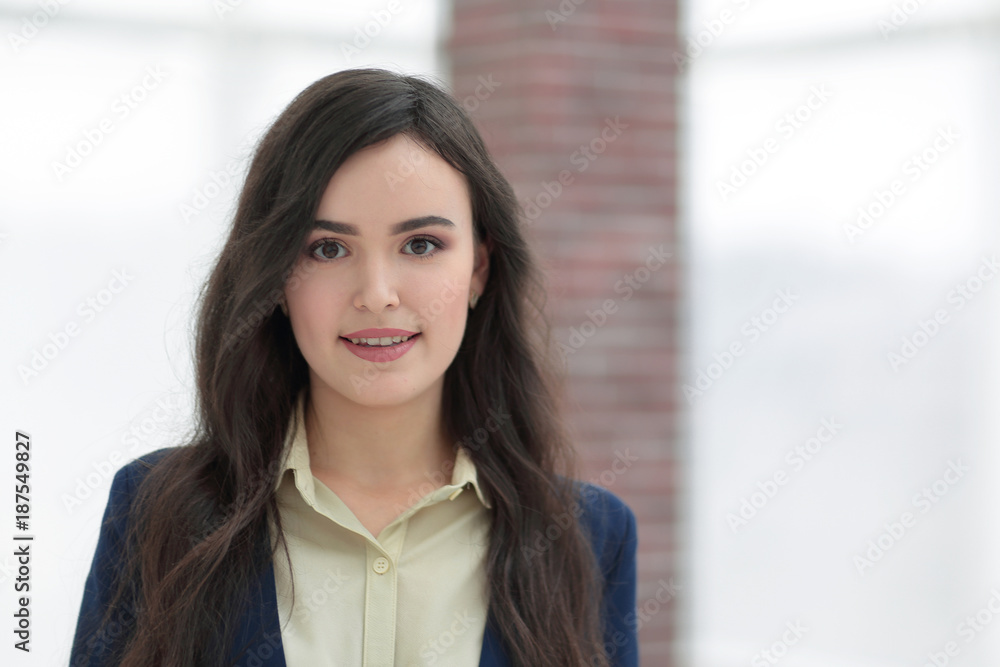 Attractive smiling young business woman in an office. Attractive smiling young business woman in an office.