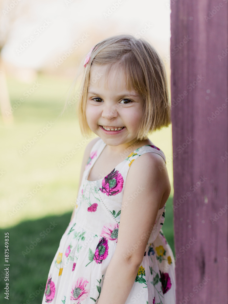 Girl in a Floral Dress by Purple Building Girl in a Floral Dress by Purple Building