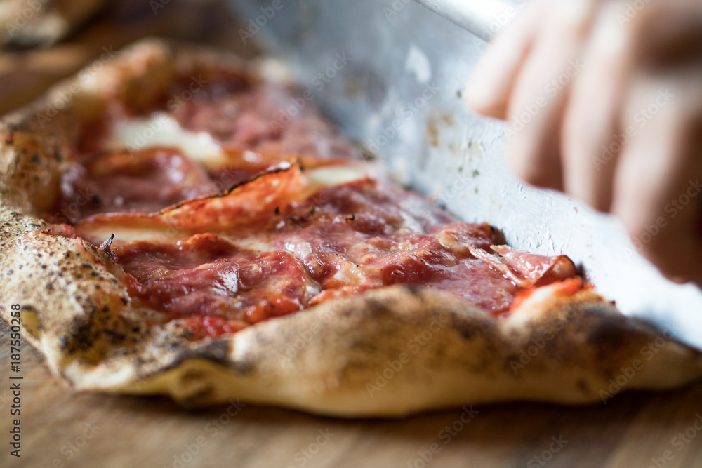 Salami being being sliced Salami being being sliced