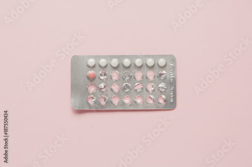 Contraceptive pills blister over pink background