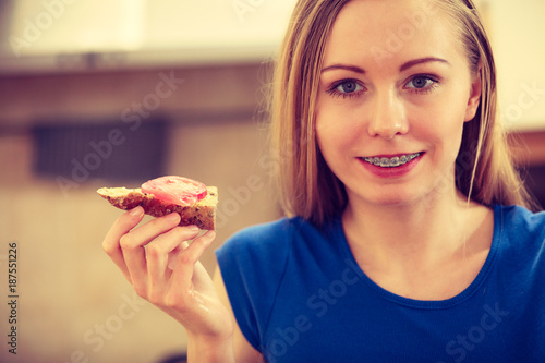 Woman having healthy breakfast eating sandwich