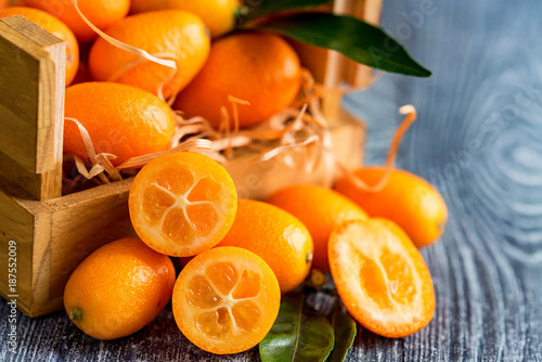 Kumquat or cumquat on wooden table