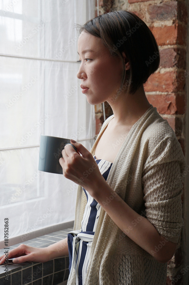 Woman drinking coffee at home Woman drinking coffee at home