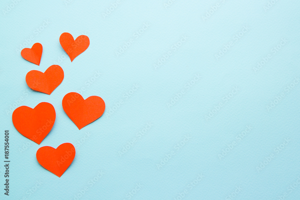 red paper hearts on a blue background