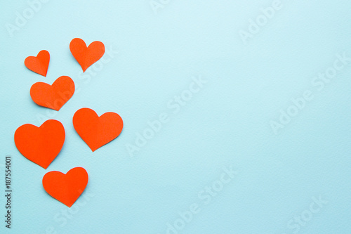 red paper hearts on a blue background