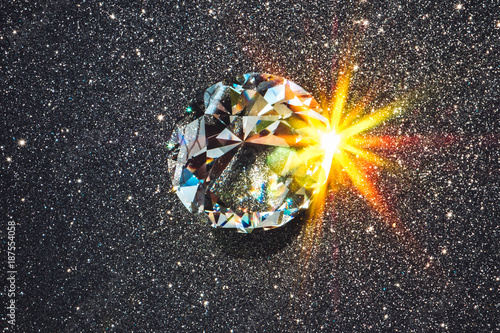 Faceted diamond reflecting burst of light photo