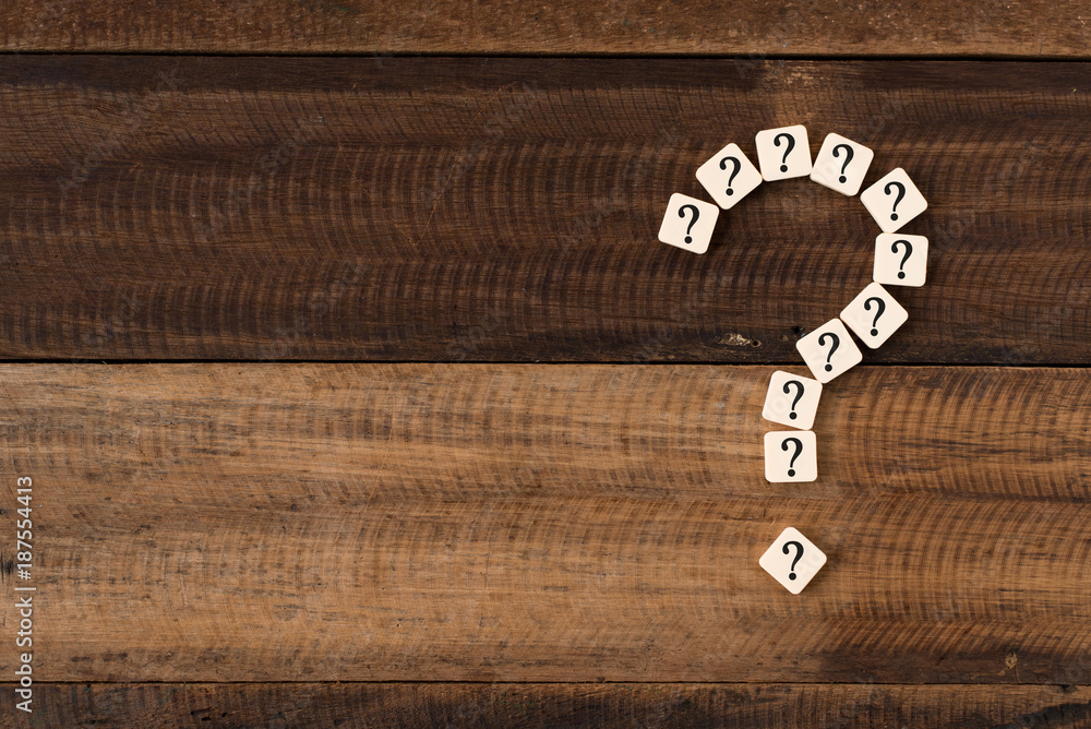question mark tiles arranged forming bigger question mark. question mark on wooden table background question mark tiles arranged forming bigger question mark. question mark on wooden table background