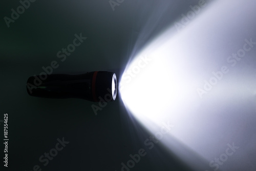 Beam of a flashlight on a white background, light and shadow concepts.