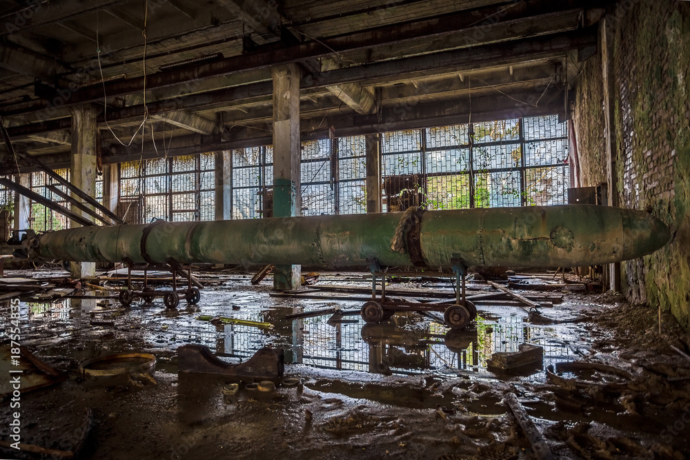 Old rusted submarine torpedo in abandoned torpedo factory