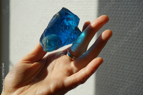 Woman holding bright blue obsidian photo
