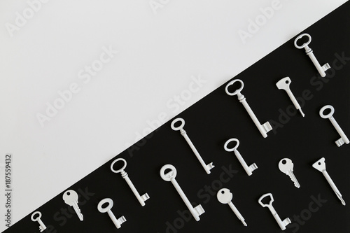 White keys forming a pattern on black diagonal background, white copyspace