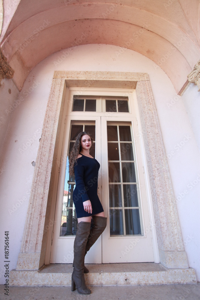 Young woman standing at the door Young woman standing at the door