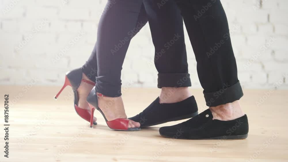 Dancers feet wearing fashion shoes - family couple is dancing kizomba in studio Dancers feet wearing fashion shoes - family couple is dancing kizomba in studio