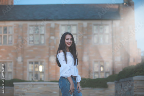 Smiling pretty woman at mansion