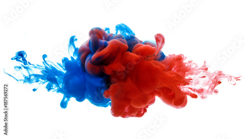 Symbol of rivalry and struggle or merging of a compound. Ink in water red and blue isolated on white