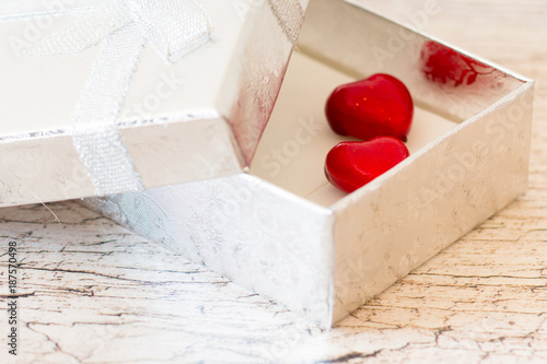 two red hearts in silver gift box