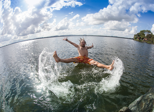 Teenage boy jumping in the river  © coob.kz