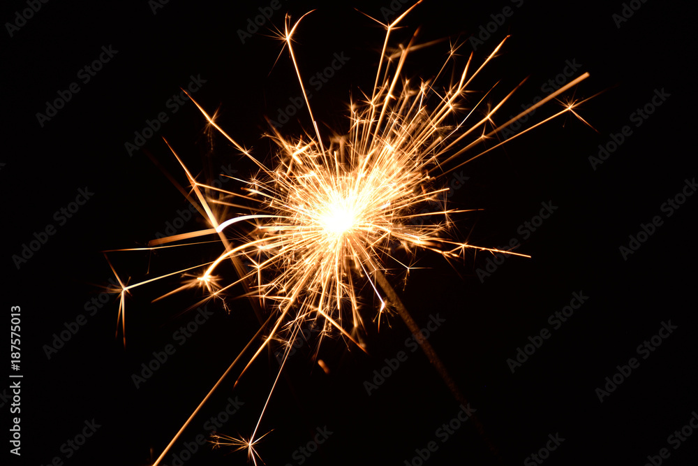 Blank background with bengal fire .Sparkler . New year party sparkler on black background A man holds a burning Bengal flame in his hands Blank background with bengal fire .Sparkler . New year party sparkler on black background A man holds a burning Bengal flame in his hands