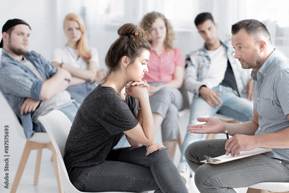 Sad girl consulting with psychotherapist Sad girl consulting with psychotherapist