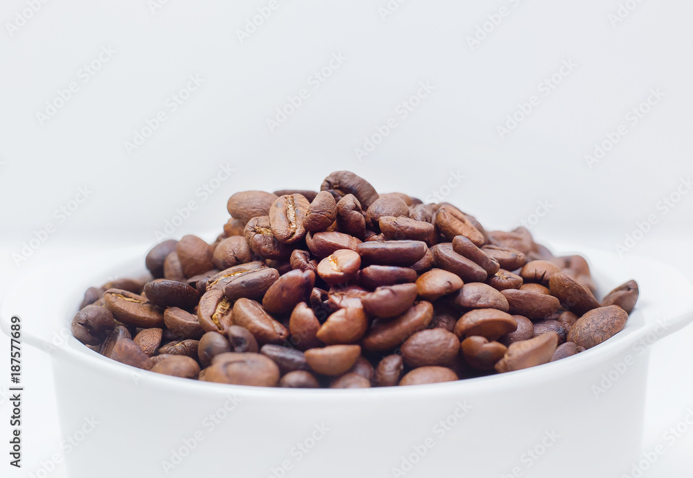 Fototapeta premium roasted coffee beans on white background space modern style.