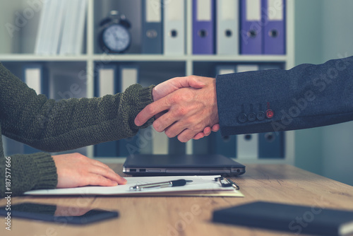 Man and woman shaking hands over business agreement