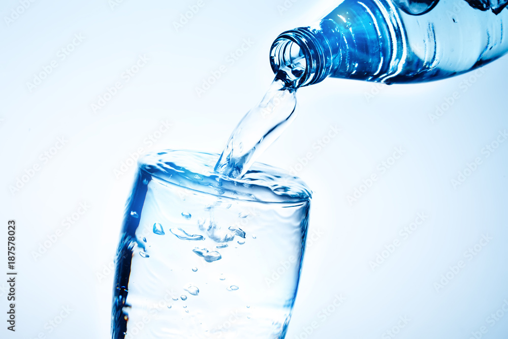 Fresh drinking water is poured in a glass. Fresh drinking water is poured in a glass.