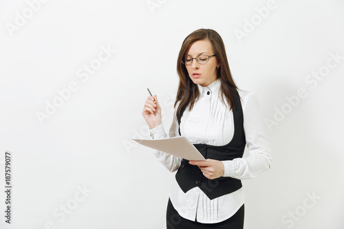 Beautiful serious caucasian young brown-hair business woman in black suit, white shirt, glasses with work paper documents isolated on white background. Manager or worker. Copy space for advertisement.