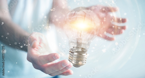 Businessman connecting modern lightbulbs with connections 3D rendering photo