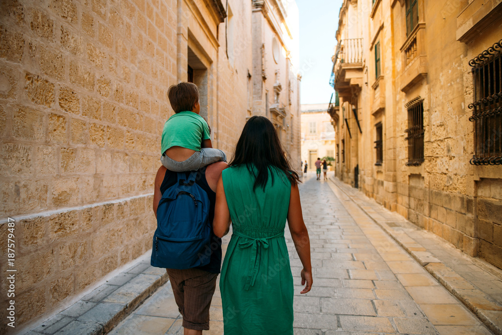 Young family with the child on the excursion in Mdina, Malta