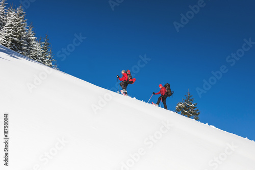 Two climbers are in the mountains.