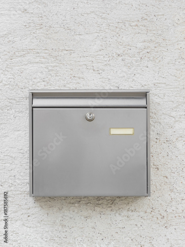 A silver mailbox on the wall