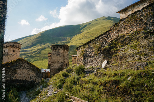 Wallpaper Mural view of grassy field with old weathered rural buildings and hills on background, Ushguli, svaneti, georgia Torontodigital.ca