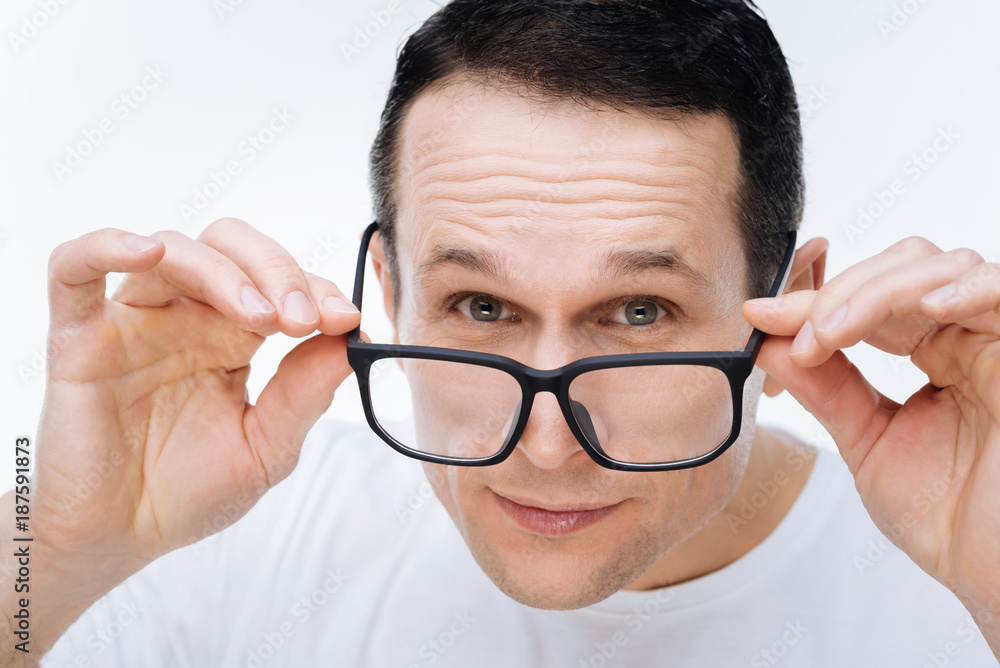 Smart guy. Portrait of a nice smear handsome man smiling and wearing glasses while looking at you Smart guy. Portrait of a nice smear handsome man smiling and wearing glasses while looking at you