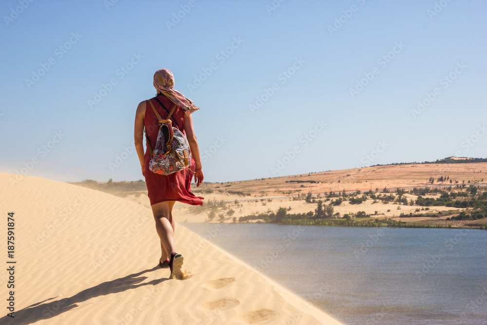 back view of lonely person with backpack walking in desert, Vietnam, Phan Thiet