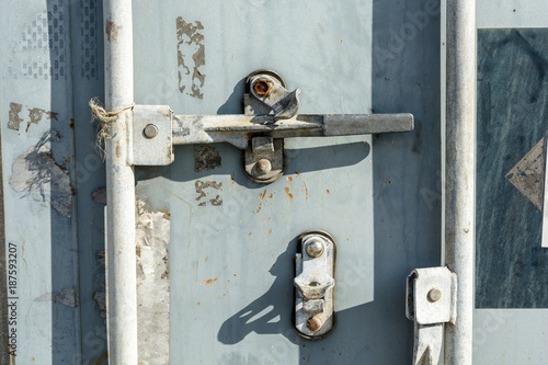 Close-up view of the worn door handle lock of an intermodal shipping container.