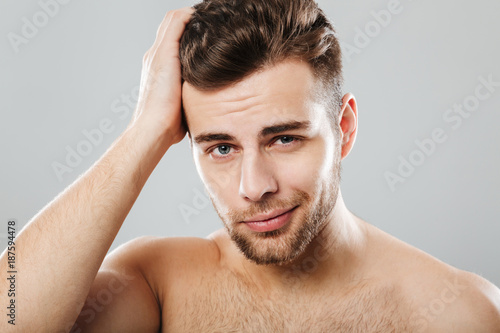 Close up portrait of a handsome man combing