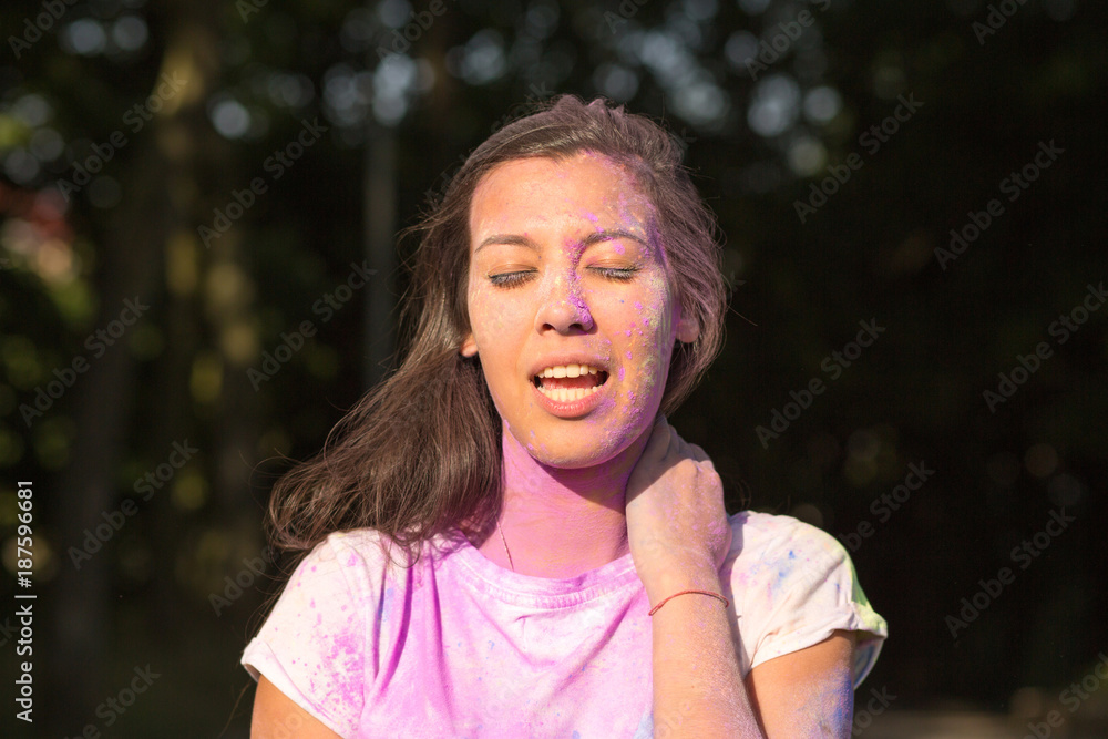 Closeup portrait of pretty young asian woman playing with purple Holi paint Closeup portrait of pretty young asian woman playing with purple Holi paint